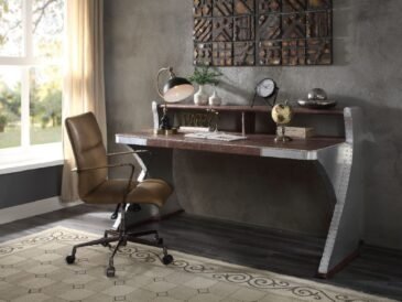 Brancaster executive writing desk with top-grain leather top and riveted aluminum sled base.