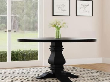 Florence 60-inch round black dining table with sculpted pedestal base.