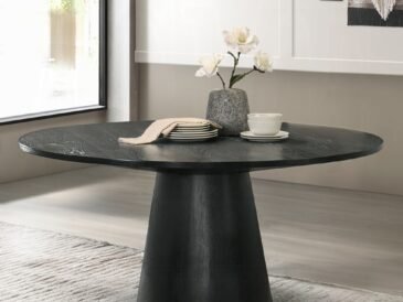 Froja round black dining table with pedestal base in modern Scandinavian style.