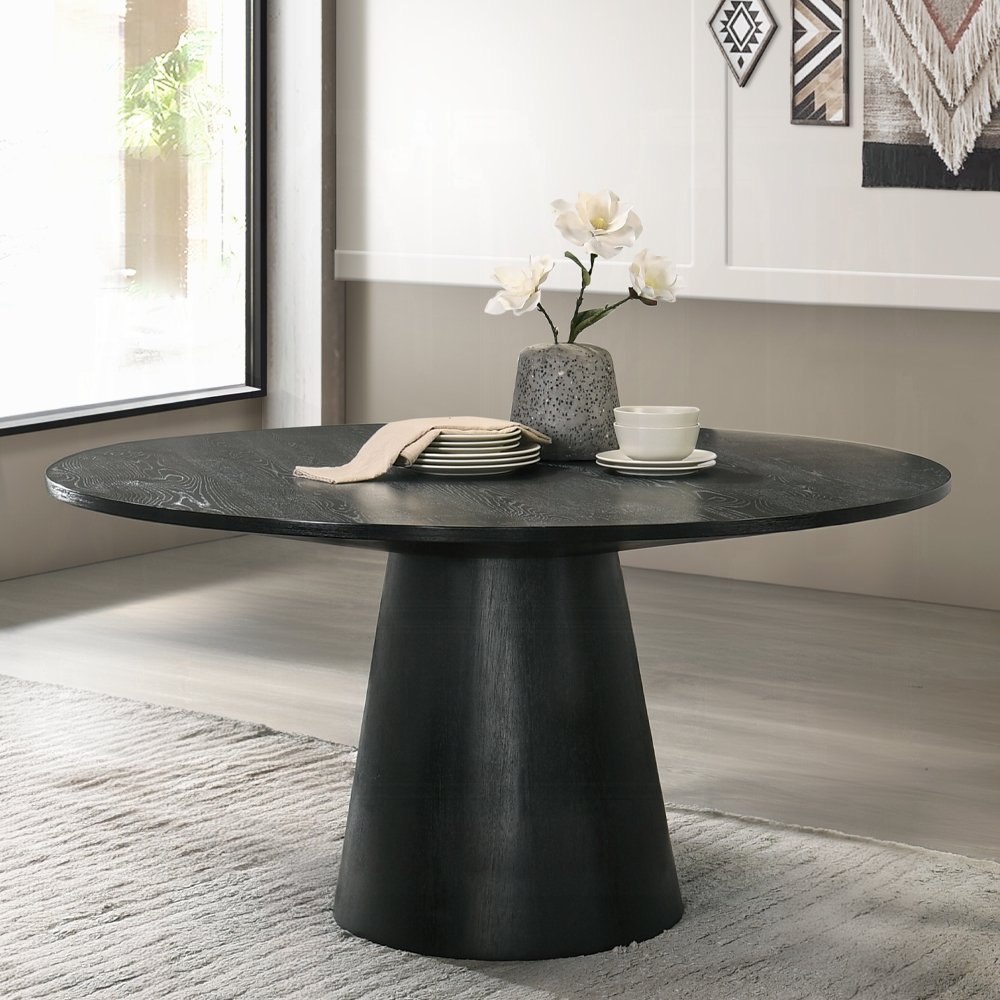 Froja round black dining table with pedestal base in modern Scandinavian style.