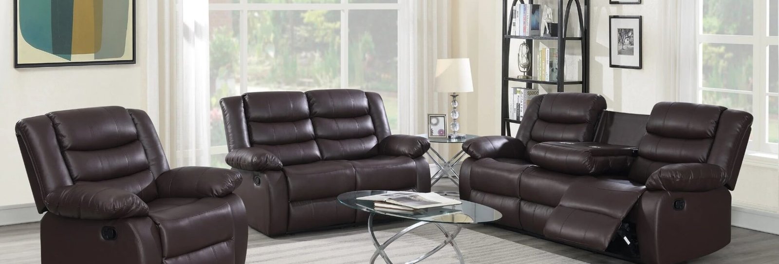Brown reclining sofa and loveseat set with drop-down table and cup holders in modern living room setting.