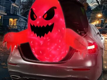 3.5-foot red inflatable Halloween ghost glowing with LED lights emerging from car trunk at night.