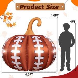 Football-themed Halloween inflatable pumpkin with LED lights glowing in a front yard surrounded by colorful fall leaves.