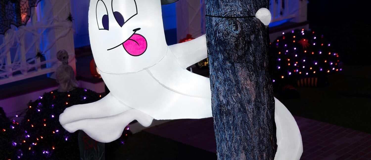 5-foot inflatable Halloween ghost with witch hat and LED lights wrapped around a tree
