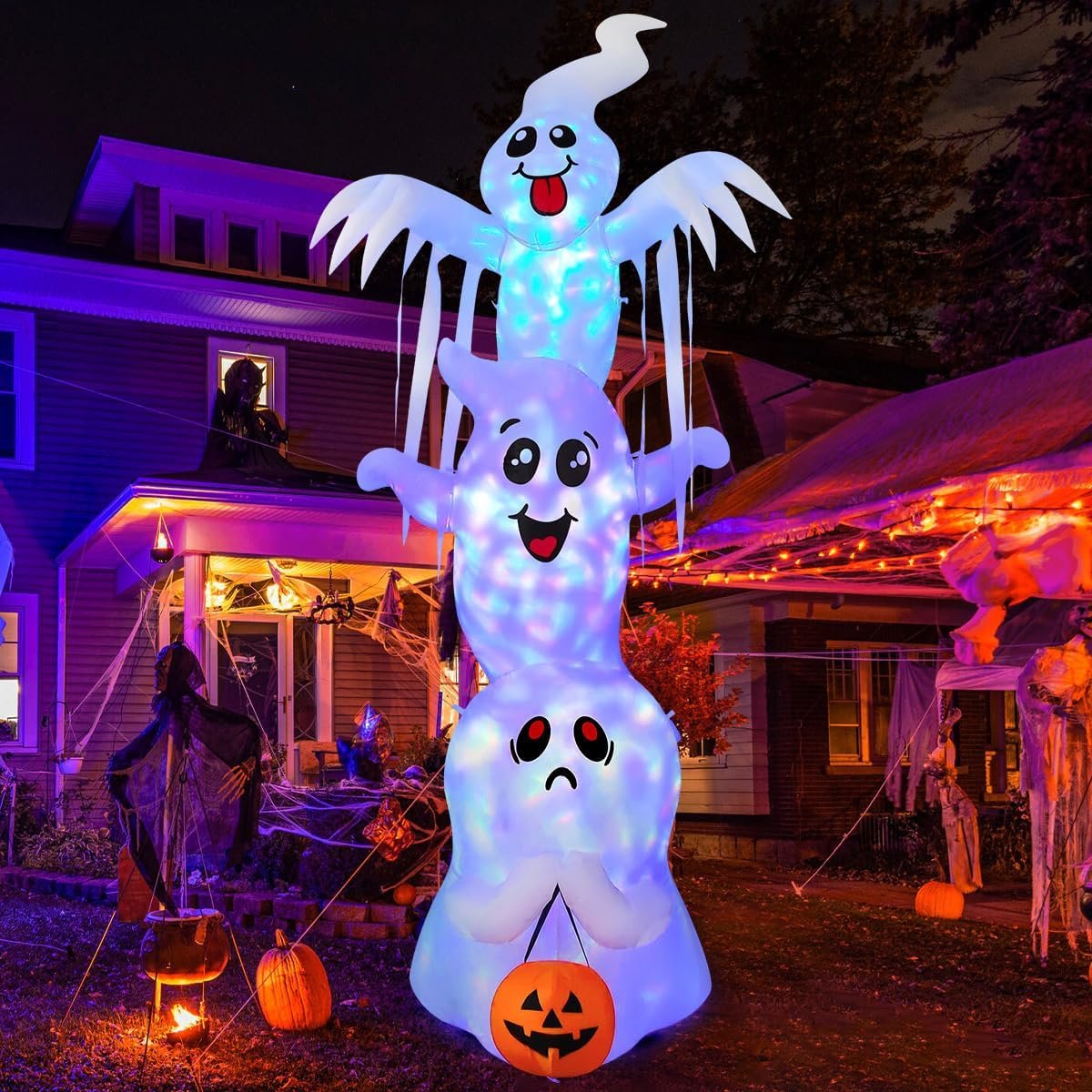 9.8-foot tall inflatable Halloween ghost decoration with built-in LED lights and pumpkin base, glowing at night in a decorated yard