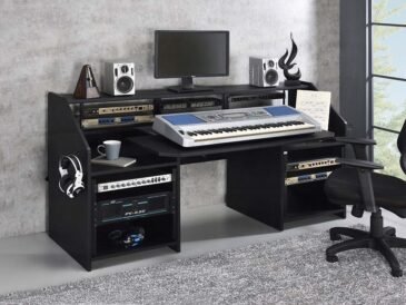 Black modern studio music desk with shelves and earphone racks.
