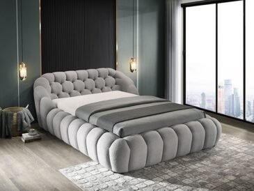 Gray chenille upholstered contemporary bed with low platform frame and minimalist design in modern bedroom setting.