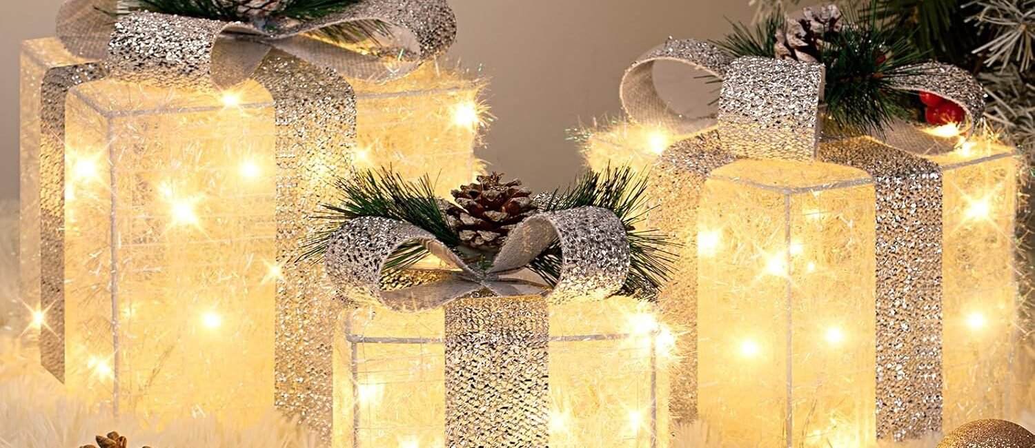 Set of three silver tinsel Christmas gift boxes with warm white LED lights and decorative bows, perfect for indoor and outdoor holiday décor.