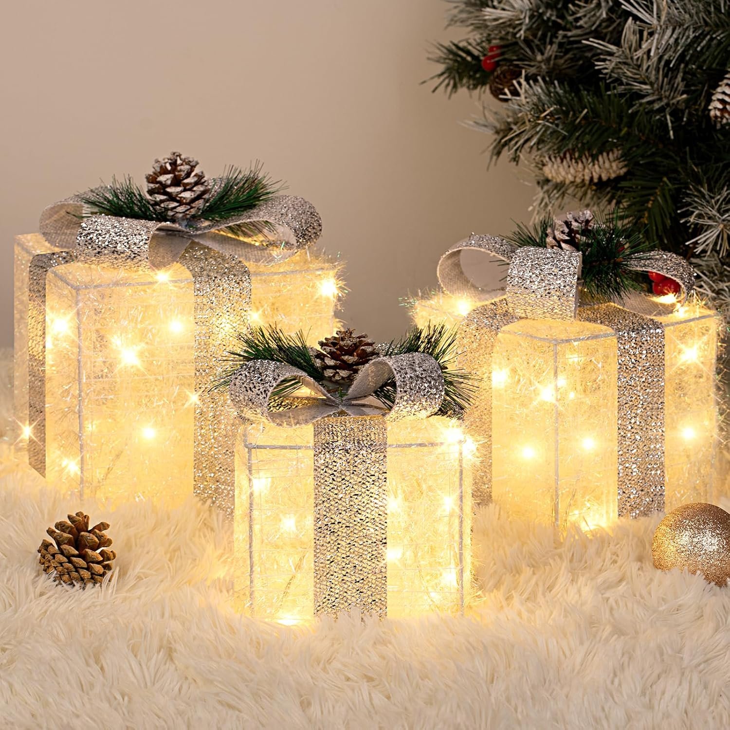 Set of three silver tinsel Christmas gift boxes with warm white LED lights and decorative bows, perfect for indoor and outdoor holiday décor.