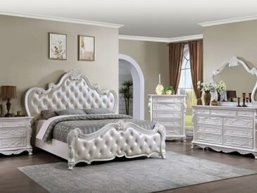 Pearl-white vintage glam bedroom set with tufted bed and carved detailing.