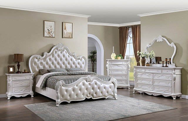 Pearl-white vintage glam bedroom set with tufted bed and carved detailing.