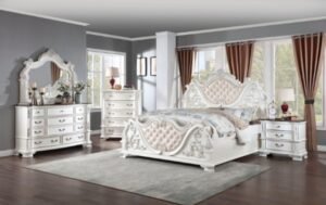 Luxury pearl white tufted bed with ornate baroque carvings and marble-topped nightstands from the Esparanza Vintage Glam Bedroom Collection.