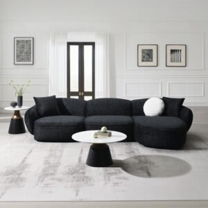 Curved black chenille sectional sofa with accent pillows in a modern living-room setting.