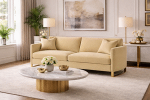 Corliss upholstered curved track arm sofa in camel velvet with gold accent legs in an elegant executive living room