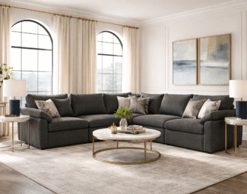 Modern living room with a dark neutral sectional styled in an elegant, light-filled interior