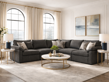 Modern living room with a dark neutral sectional styled in an elegant, light-filled interior