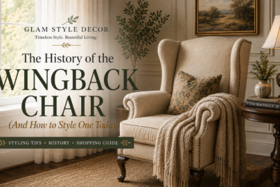 Cream wingback chair with nailhead trim styled beside a dark wood table in an elegant living room, featured in a guide to wingback chair history and styling.