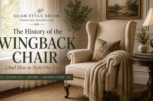 Cream wingback chair with nailhead trim styled beside a dark wood table in an elegant living room, featured in a guide to wingback chair history and styling.