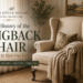 Cream wingback chair with nailhead trim styled beside a dark wood table in an elegant living room, featured in a guide to wingback chair history and styling.